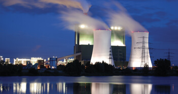 Exterior view of a power plant alongside of a water system