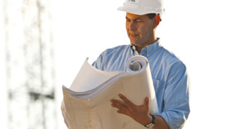 Engineer reviewing blueprints on a job-site